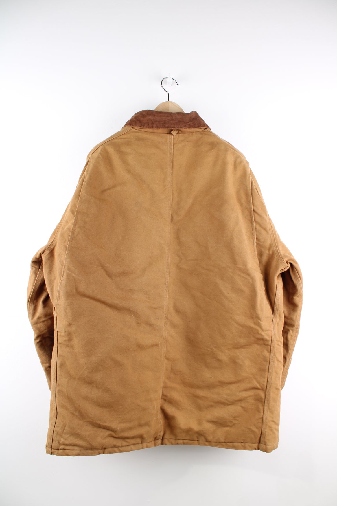 Carhartt Arctic Jacket in a tanned colourway with a brown corduroy collar, zip up, multiple pockets, and has the logo embroidered on the front.