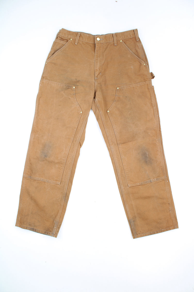 Carhartt double knee carpenter jeans in tan with multiple pockets and signature logo on the back pocket