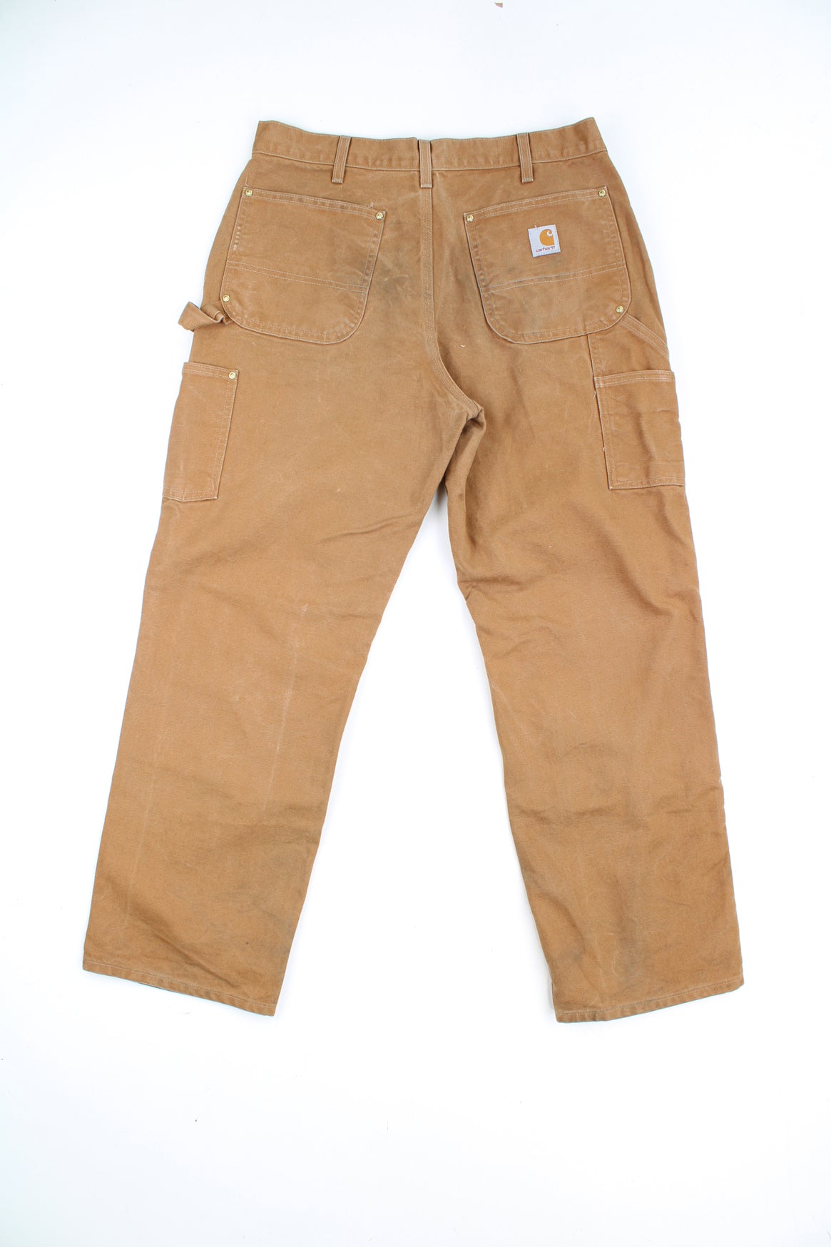 Carhartt double knee carpenter jeans in tan with multiple pockets and signature logo on the back pocket