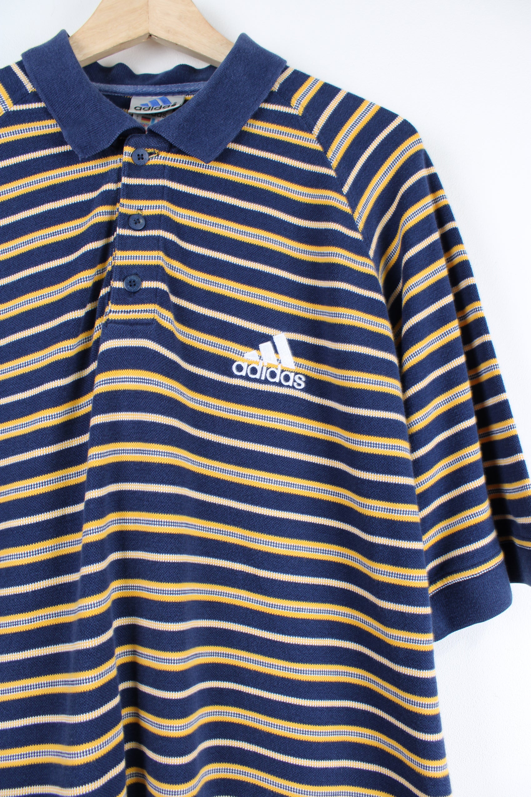 Vintage Adidas blue and yellow striped polo shirt with embroidered Adidas logo.