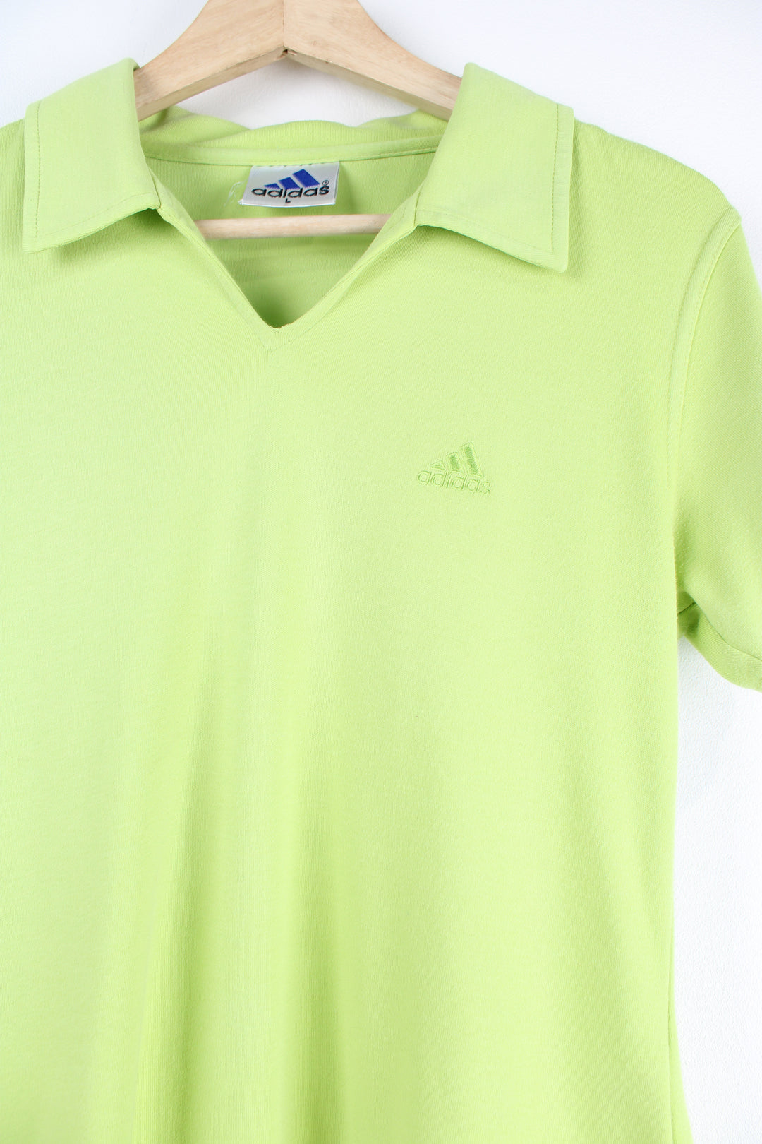 Vintage 90's Adidas green polo shirt with embroidered Adidas logo.