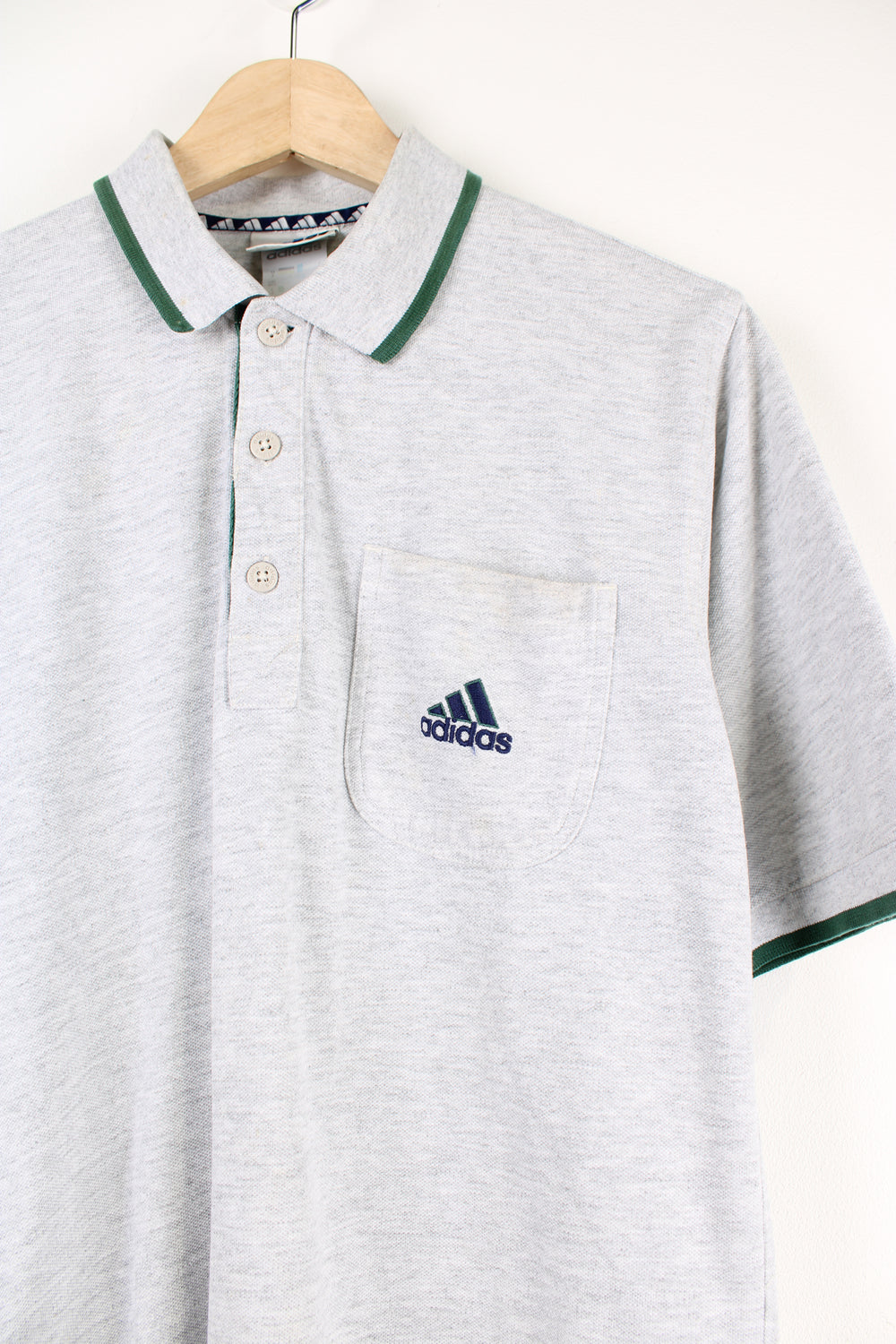 Vintage 90's Adidas grey polo shirt with embroidered Adidas logo.