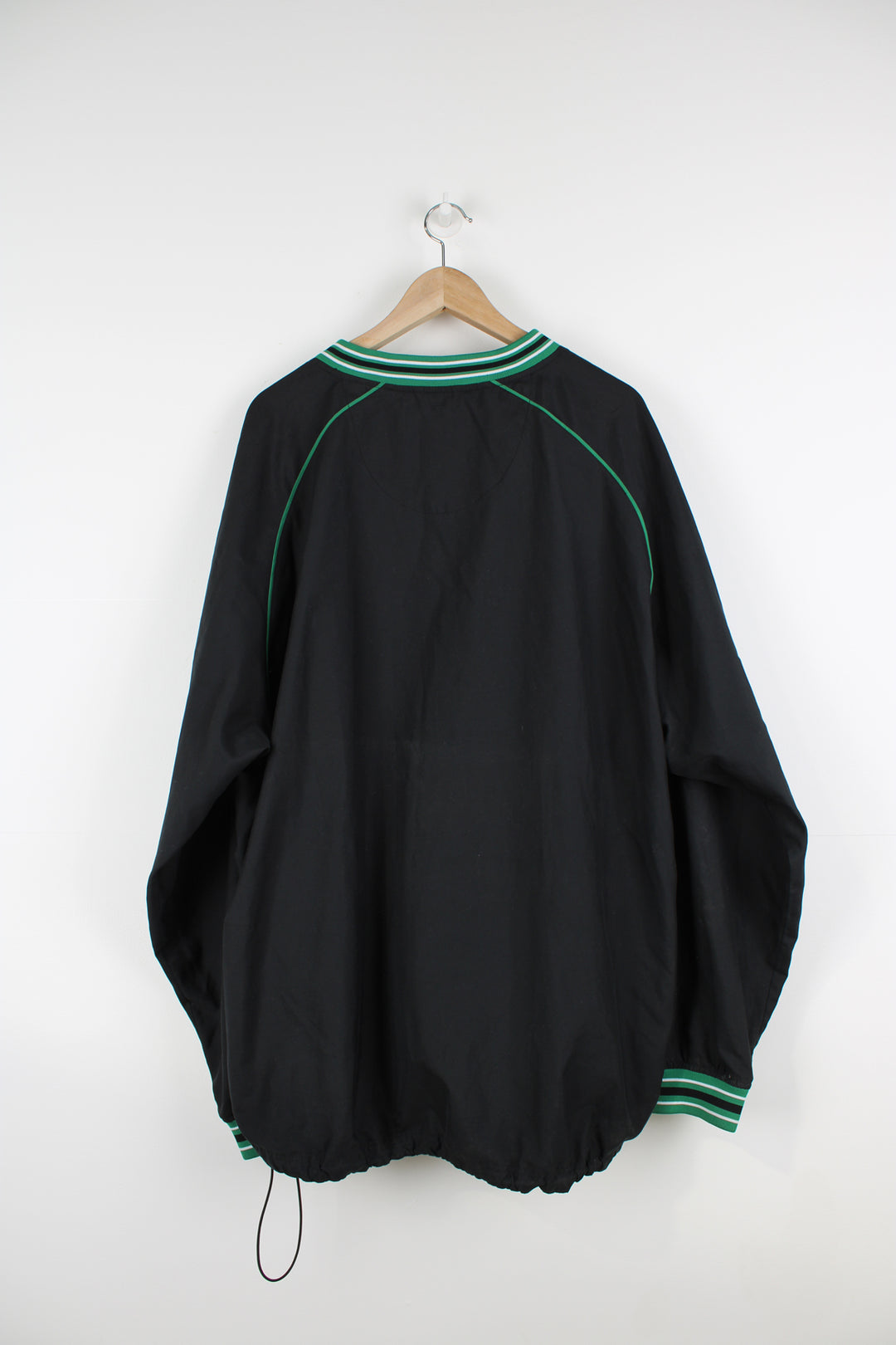 Boston Celtics all black nylon training top/pull over, by Adidas. Features embroidered spell-out logo across the chest, pockets and drawstring waist