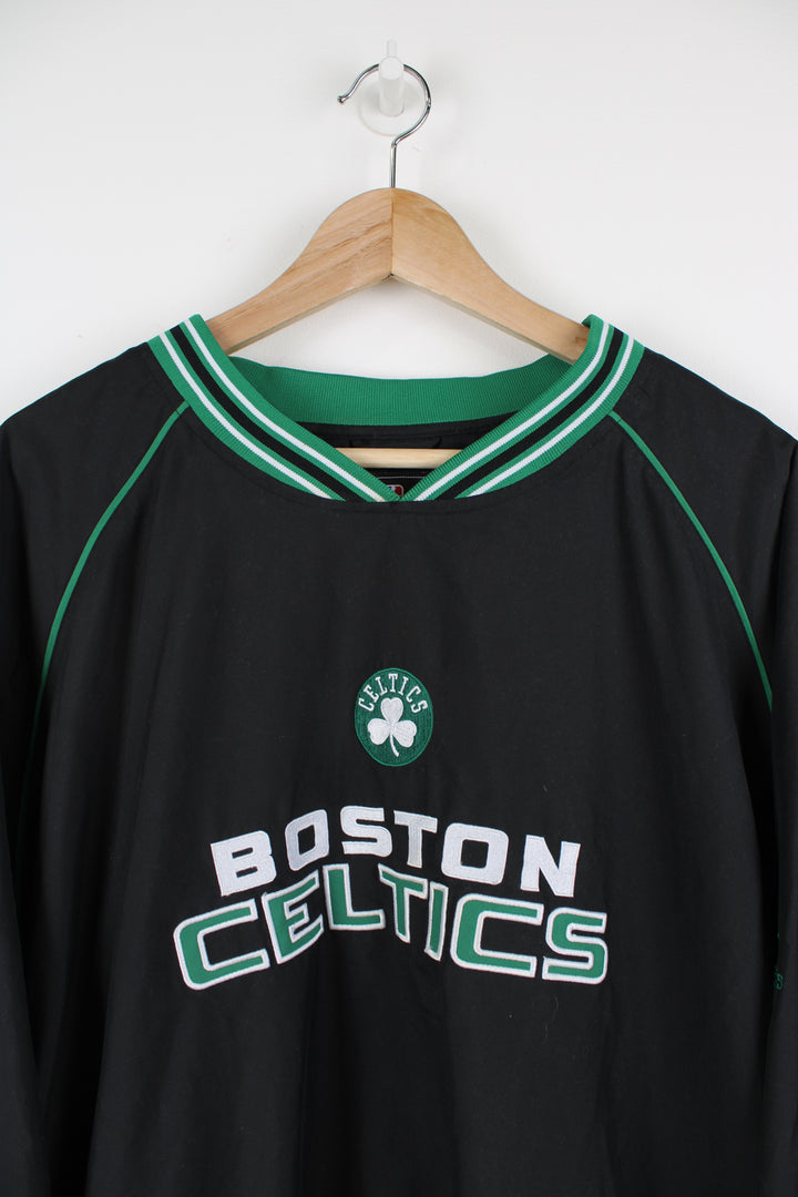 Boston Celtics all black nylon training top/pull over, by Adidas. Features embroidered spell-out logo across the chest, pockets and drawstring waist