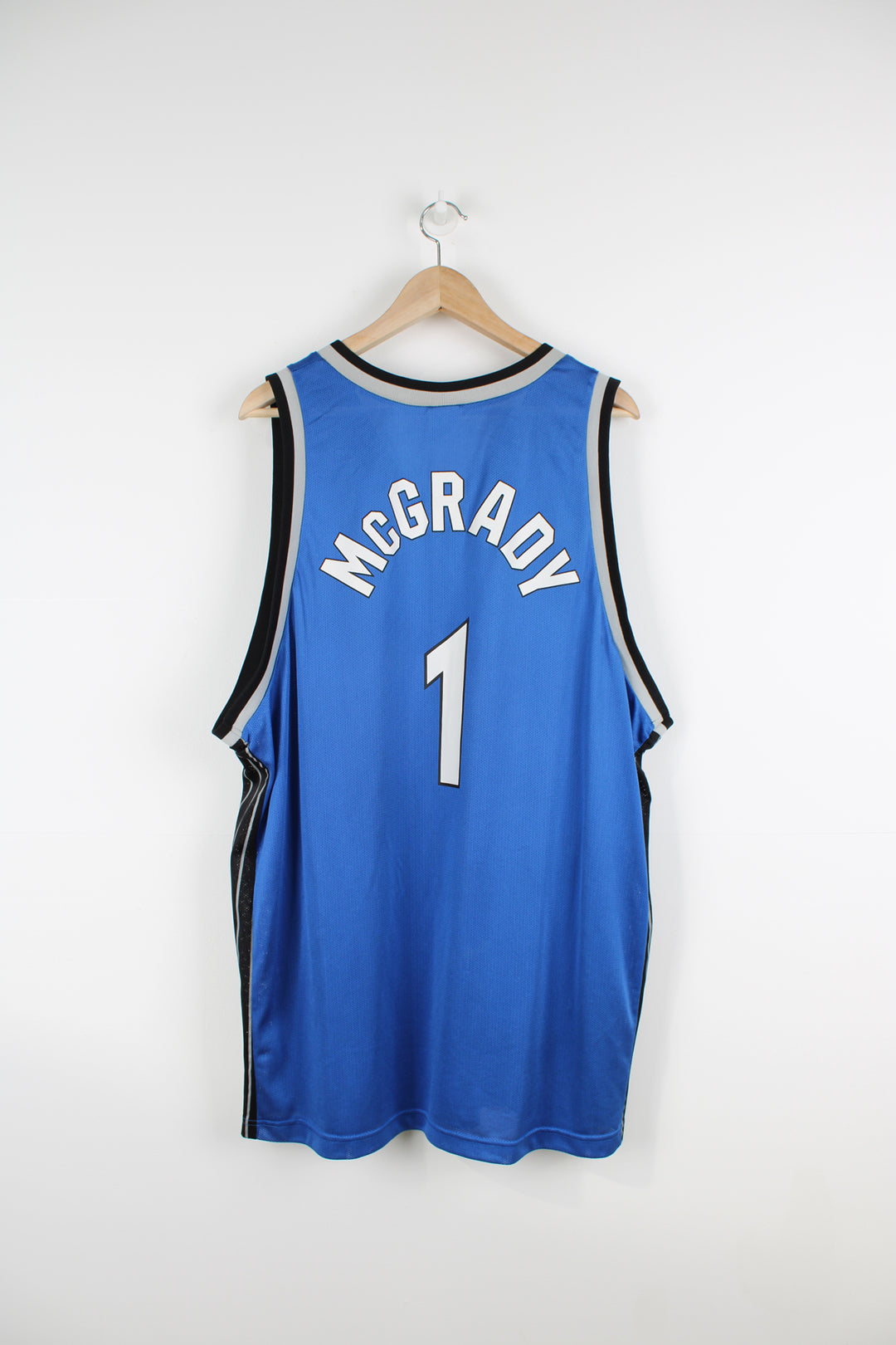 Tracy McGrady Orlando Magic basketball jersey by Champion, features embroidered Champion logo on the chest and spell-out details on the front and back  