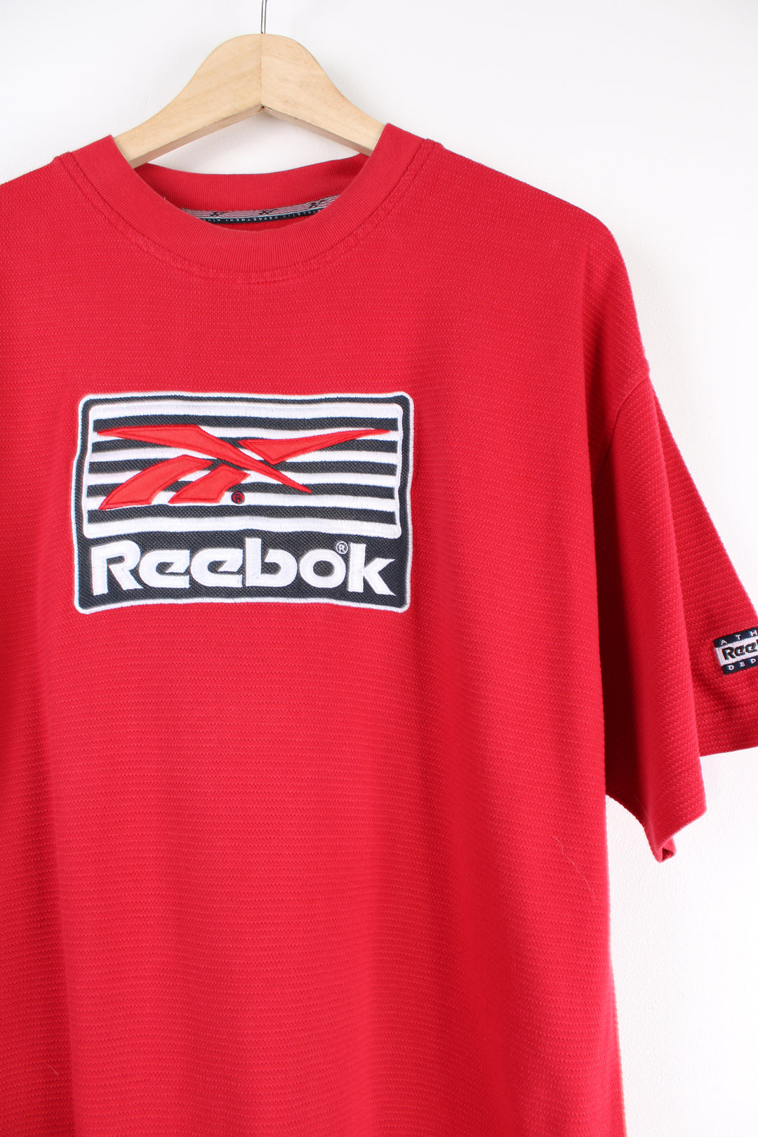 Vintage 90's Reebok red T-shirt with embroidered spell-out Reebok across the front. 