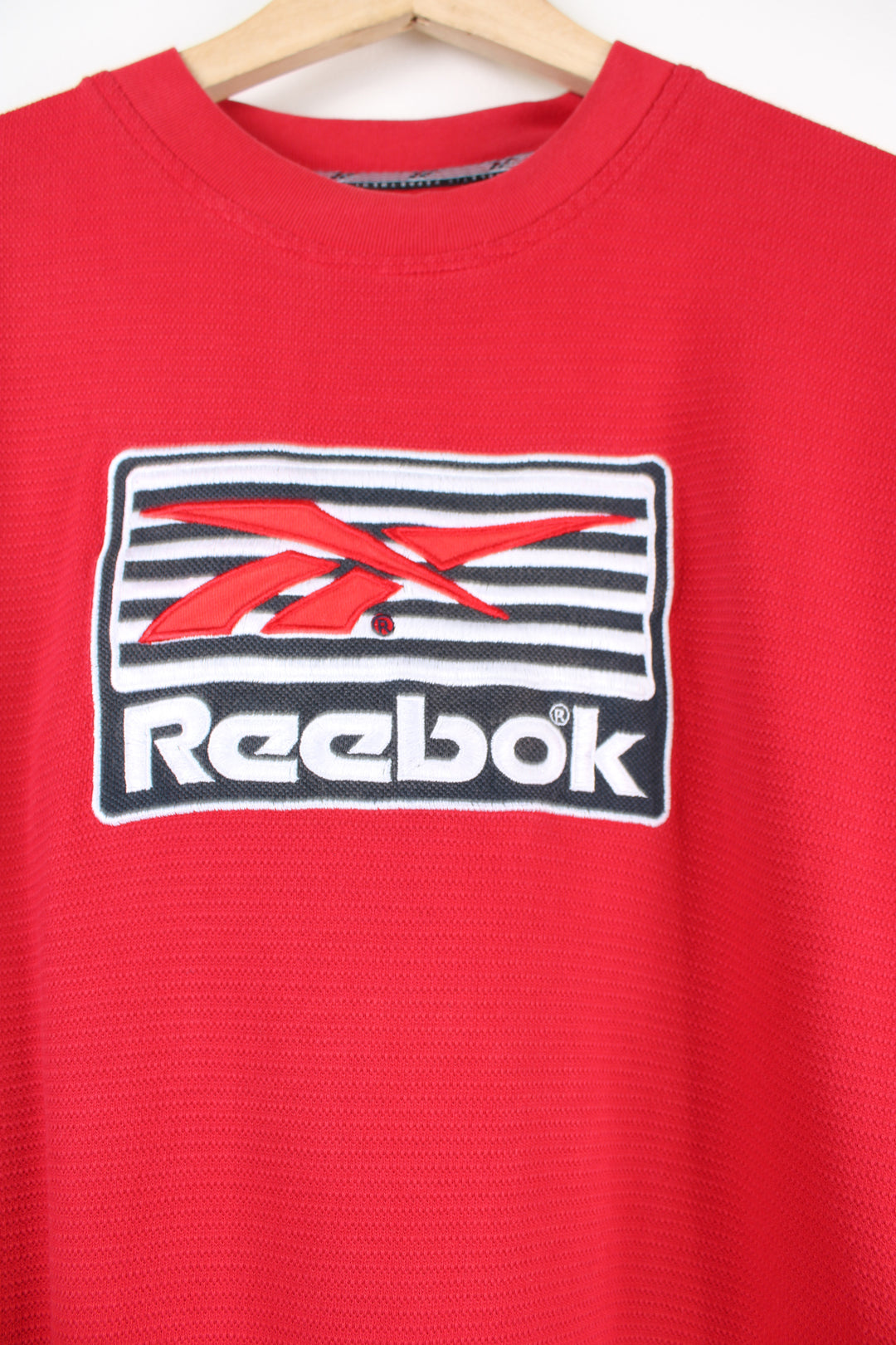 Vintage 90's Reebok red T-shirt with embroidered spell-out Reebok across the front. 