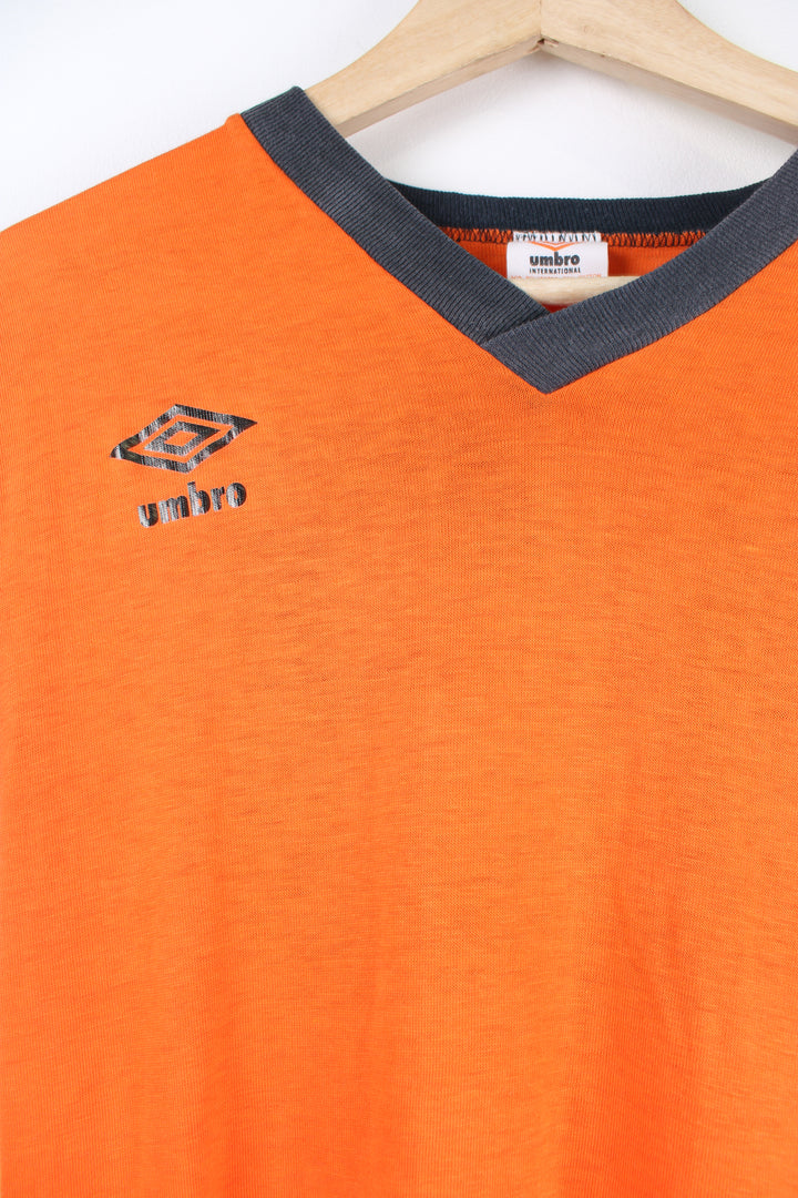 Vintage 90's Umbro sports v neck t-shirt with logo on the front and sleeve, as well as the number 13 printed on the back. 