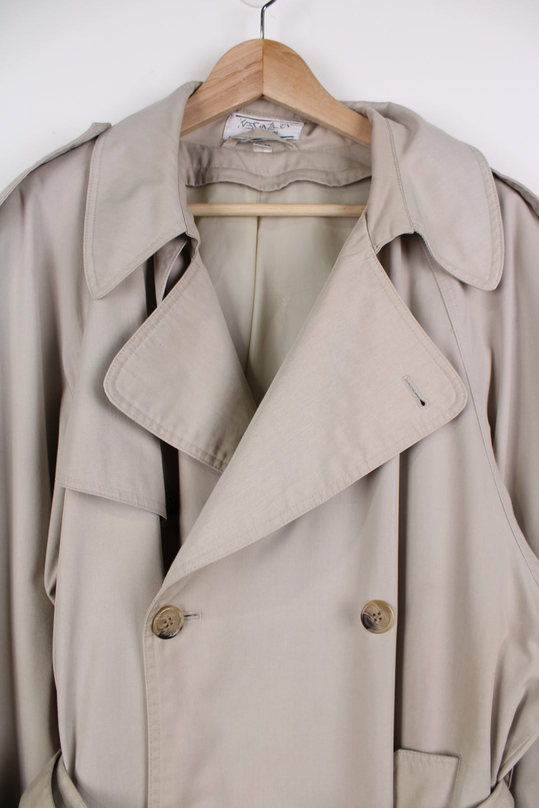 Vintage Yves Saint Laurent tan button up trench coat, features branded lining and belt 