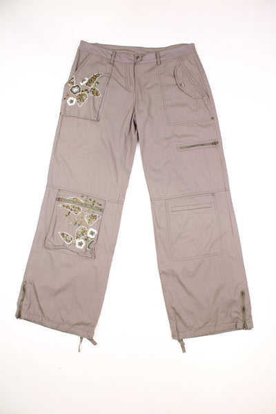 Vintage Unbranded Y2K Floral Cargo Trousers in a khaki green colourway, low rise, multiple pockets, and has floral designs embroidered with beads throughout the trousers.
