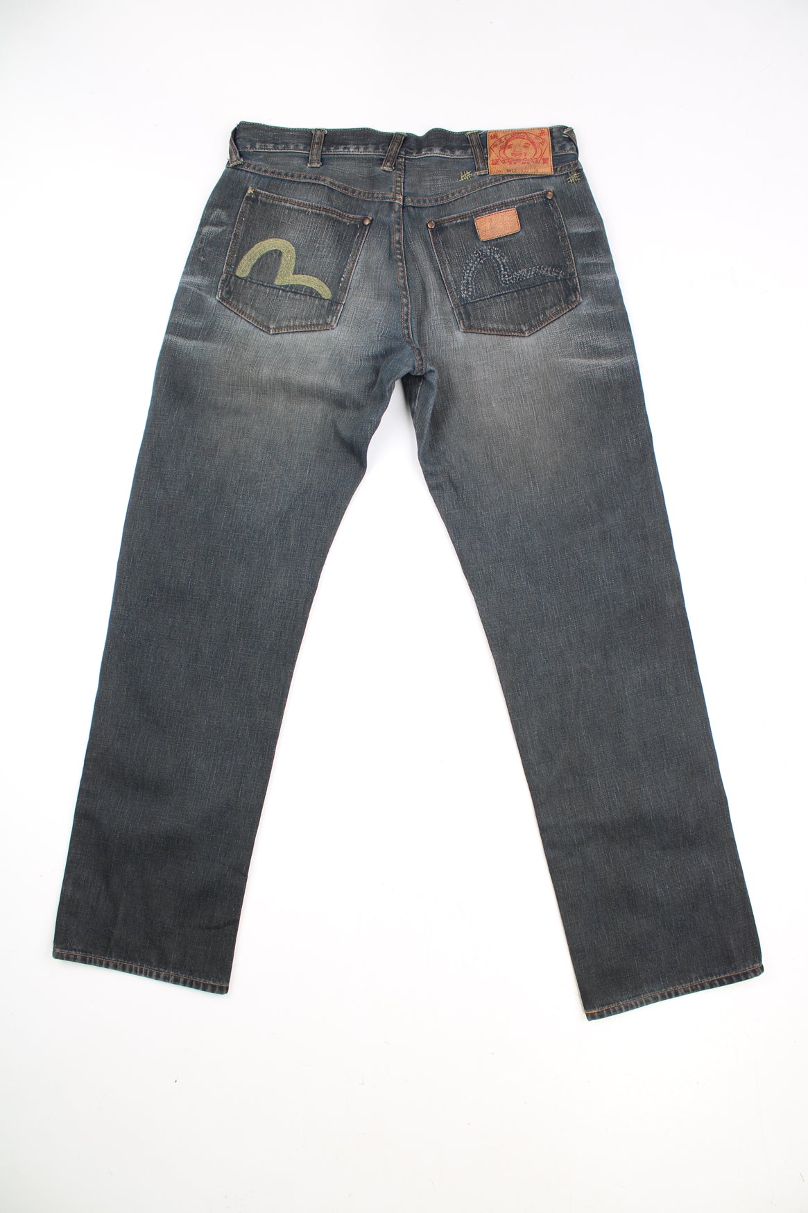 Evisu Y2K Jeans in a dark grey colourway with a striped wash design throughout, multiple pockets, and has the logo embroidered on the back pockets.