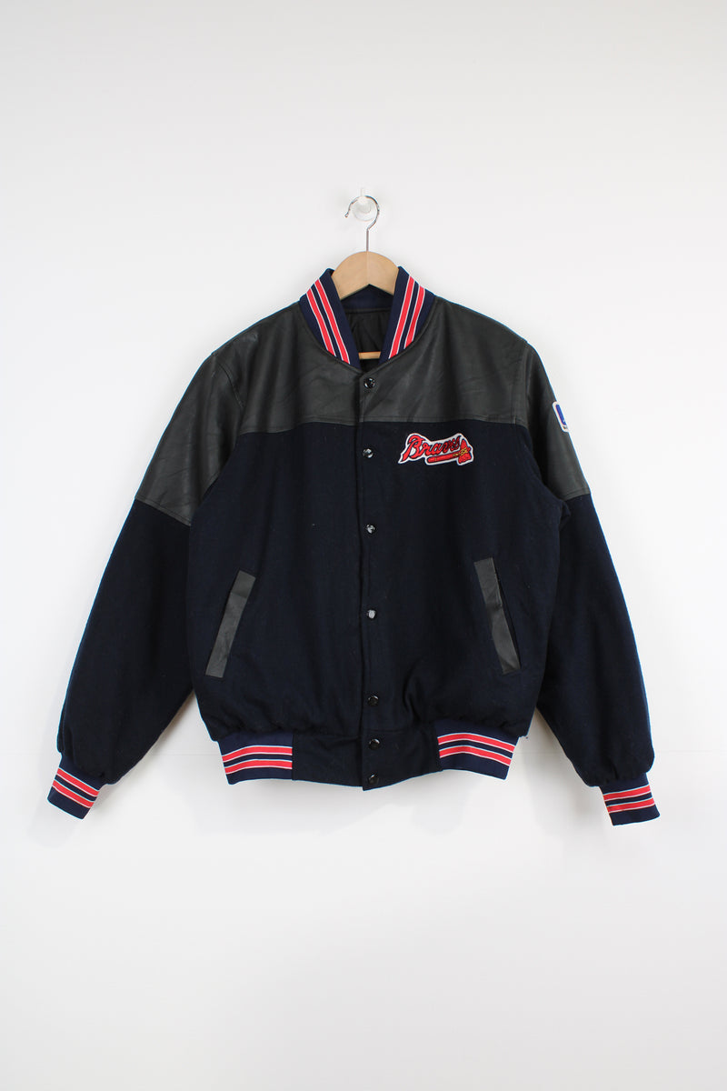 Vintage MLB Atlanta Braves navy blue wool varsity jacket with pleather detail on the shoulders. Features embroidered Atlanta Braves logo across the chest and back. . Good Condition some light marks Size in Label: No Size label - Mens S 