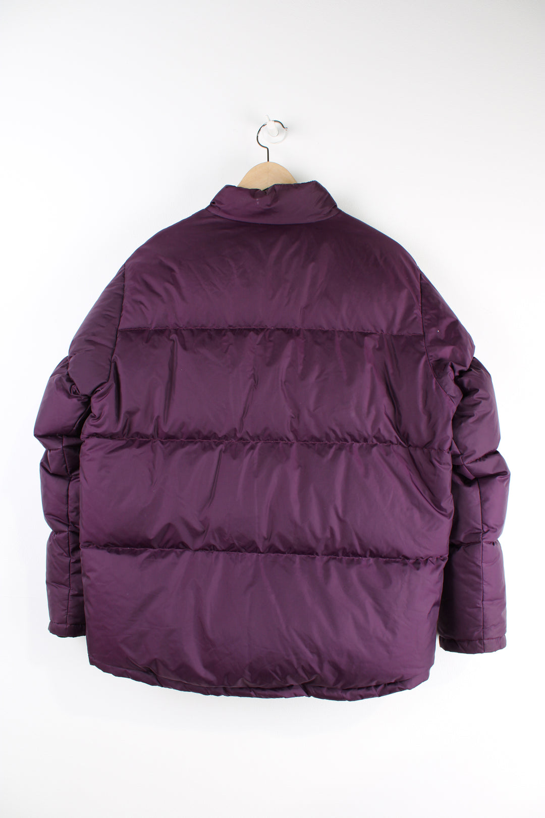 Fred Perry purple puffer jacket features embroidered logo on the chest and drawstring hem