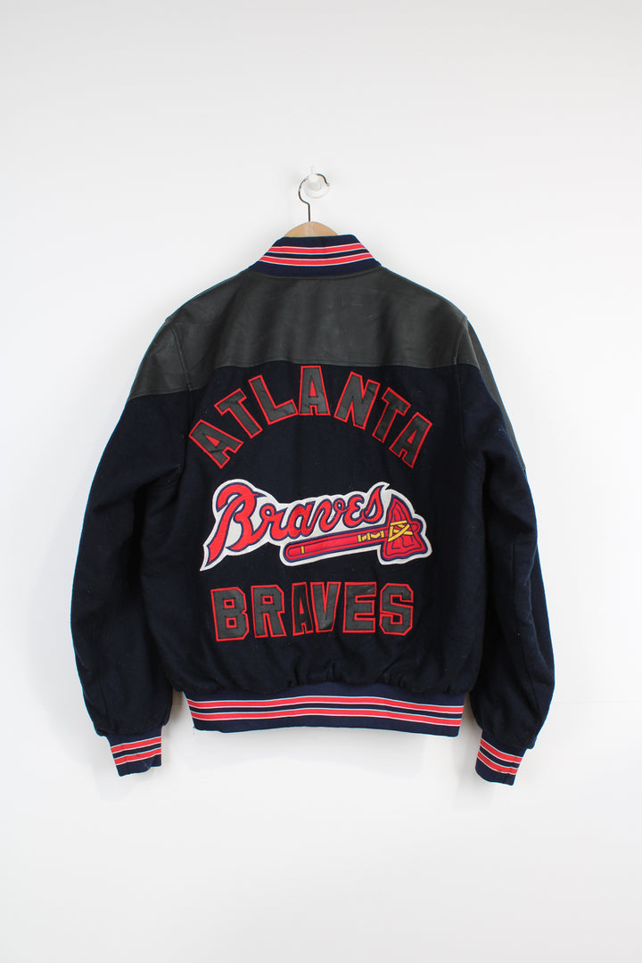 Vintage MLB Atlanta Braves navy blue wool varsity jacket with pleather detail on the shoulders. Features embroidered Atlanta Braves logo across the chest and back. . Good Condition some light marks Size in Label: No Size label - Mens S 