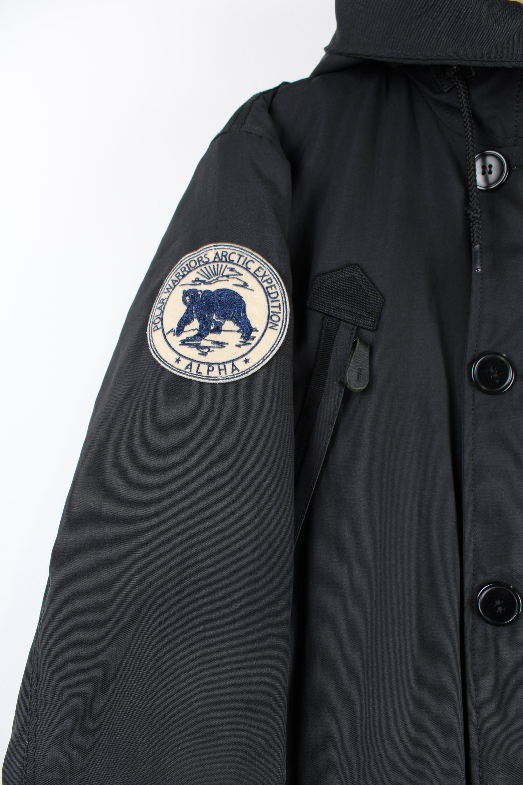 Vintage Alpha Industries black parka coat, features multiple pockets, faux fur lined hood and embroidered badge on the shoulder