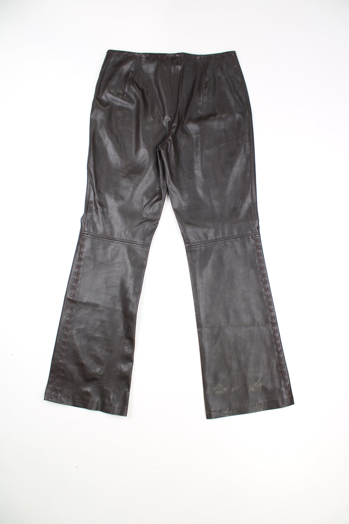 Vintage Leather Trousers in a brown colourway, mid rise, and has cross stitching design going around the waist and down the side of the legs.