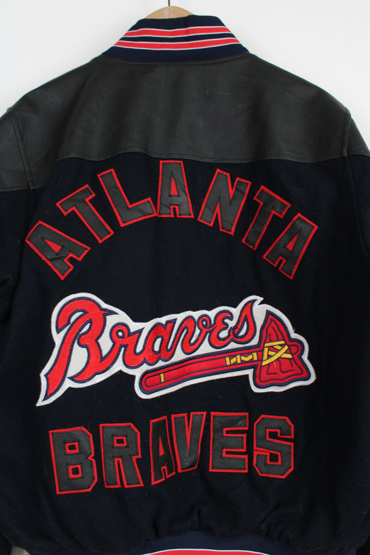 Vintage MLB Atlanta Braves navy blue wool varsity jacket with pleather detail on the shoulders. Features embroidered Atlanta Braves logo across the chest and back. . Good Condition some light marks Size in Label: No Size label - Mens S 