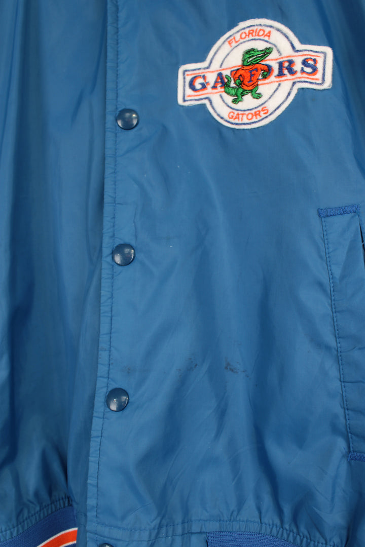 Vintage 90's Florida Gators thin varsity bomber Jacket, from Chalk Line by. Features embroidered Gators logo on the chest and closes with snap buttons down the front.  Size in Label: Mens M