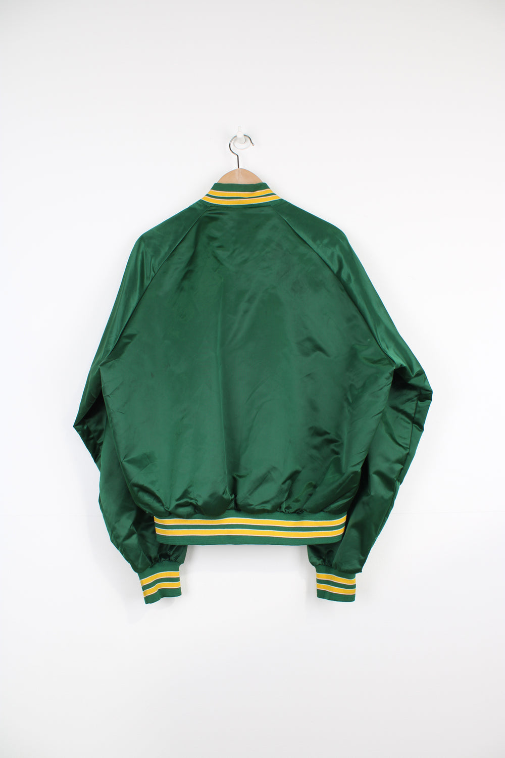 Boston Celtics, NBA Chalk Line Varsity Jacket in a green, white and yellow team colourway, satin material, button up, and has the logo embroidered on the chest.