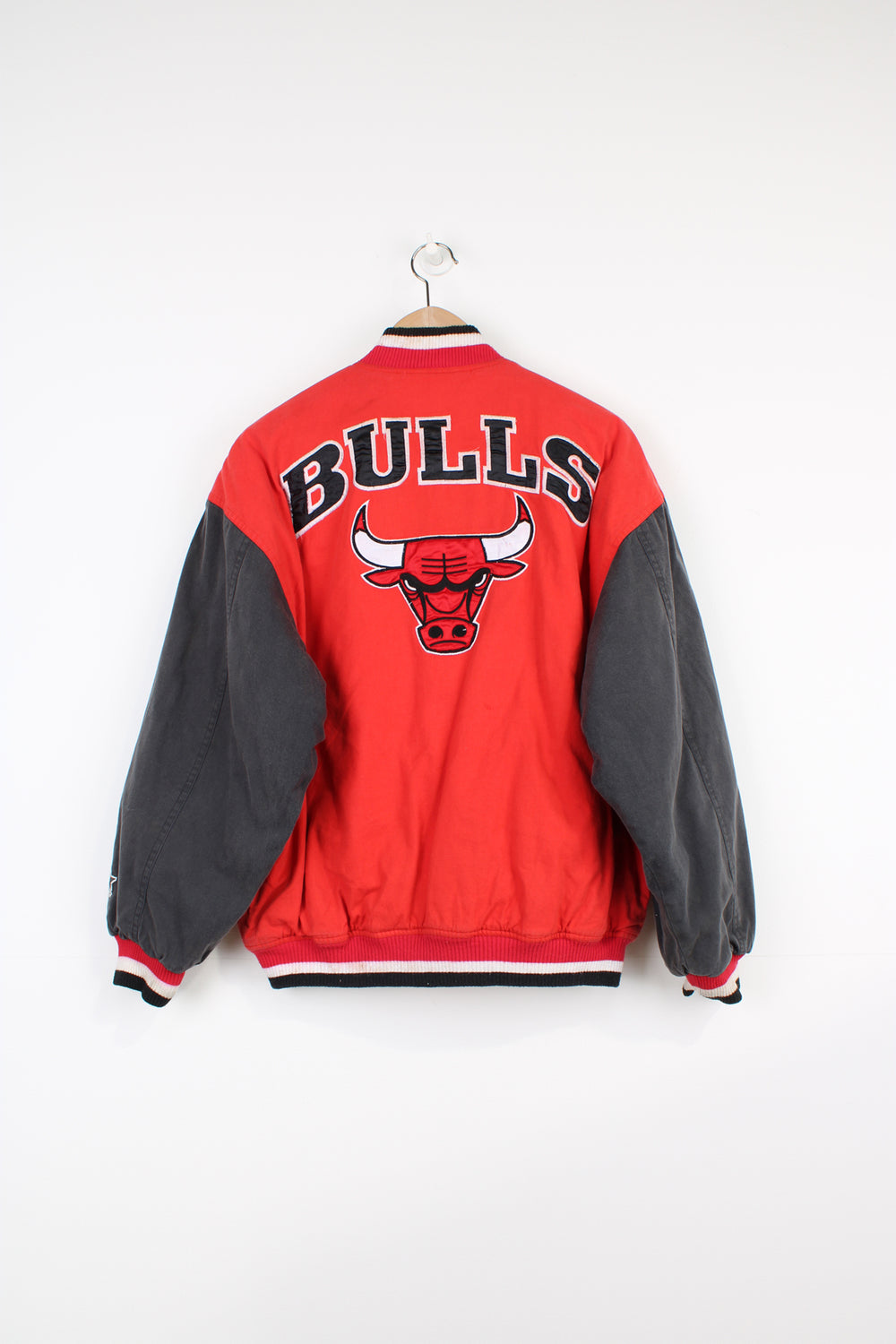 Chicago Bulls NBA, Starter Varsity Jacket in the red, black and white team colourway, cotton material with a polyester lining, button up, and has logos embroidered on the front and back.