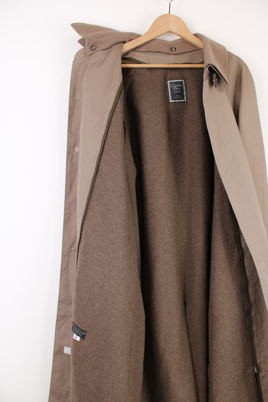 Chrisitan Dior Monsieur button up trench coat, in a light brown. Features a wool liner jacket and collar