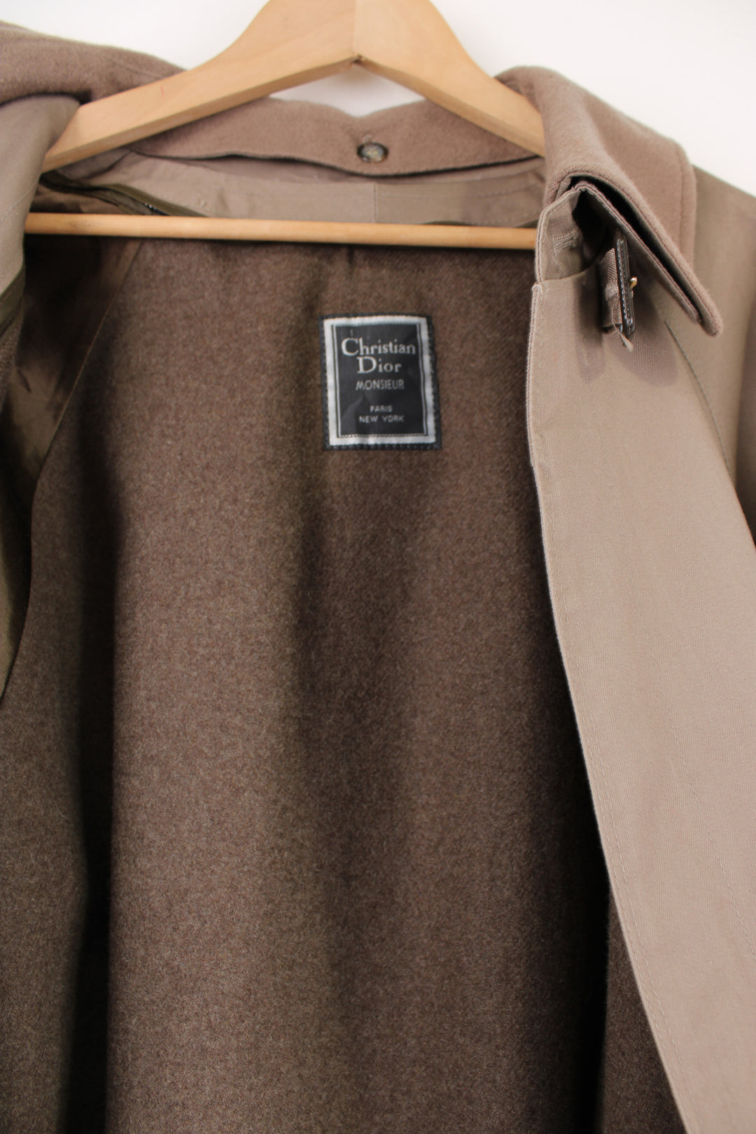 Chrisitan Dior Monsieur button up trench coat, in a light brown. Features a wool liner jacket and collar