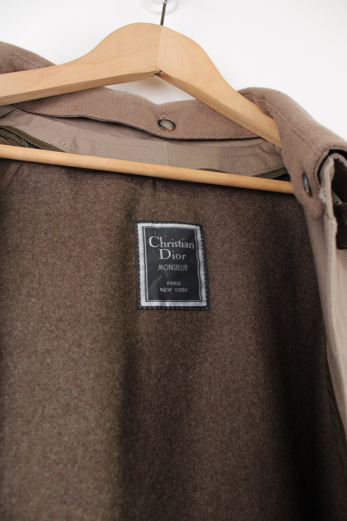 Chrisitan Dior Monsieur button up trench coat, in a light brown. Features a wool liner jacket and collar