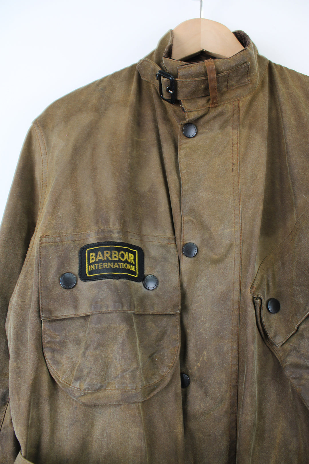 Barbour International A10 motorcycle style wax jacket in khaki green/brown features multiple pockets and belt