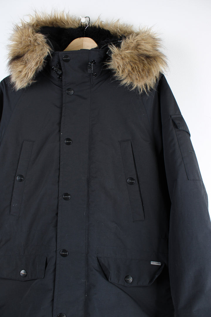 Vintage Carhartt black parka jacket with quilted lining, fur hood and multiple pockets.