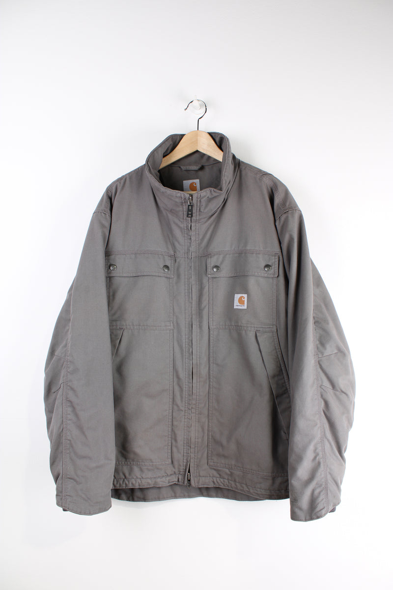 Carhartt workwear heavy duty cotton zip through jacket in grey with multiple pockets and logo on the chest.