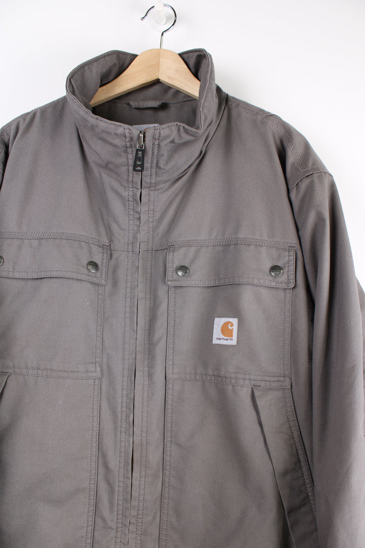 Carhartt workwear heavy duty cotton zip through jacket in grey with multiple pockets and logo on the chest.