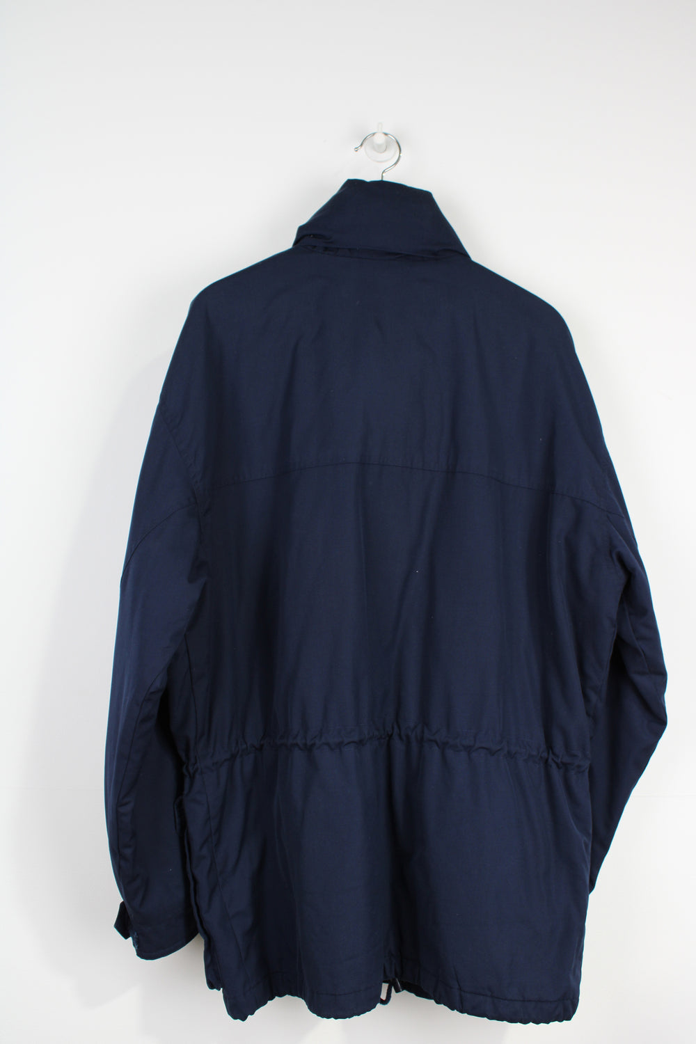 Fila, navy blue sports coat with multiple pockets, foldaway hood and embroidered logo on the sleeve