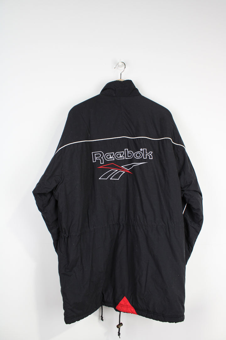 Reebok black zip through sports coat, with embroidered logo on the chest and back of the coat 