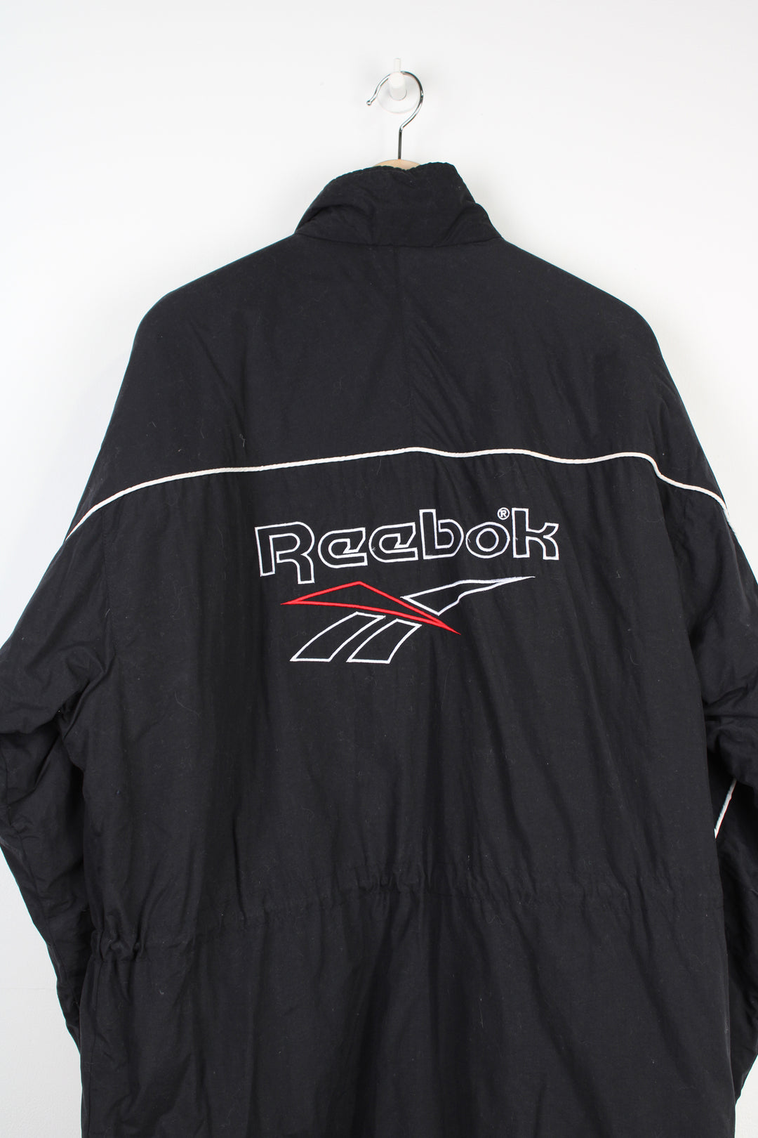 Reebok black zip through sports coat, with embroidered logo on the chest and back of the coat 