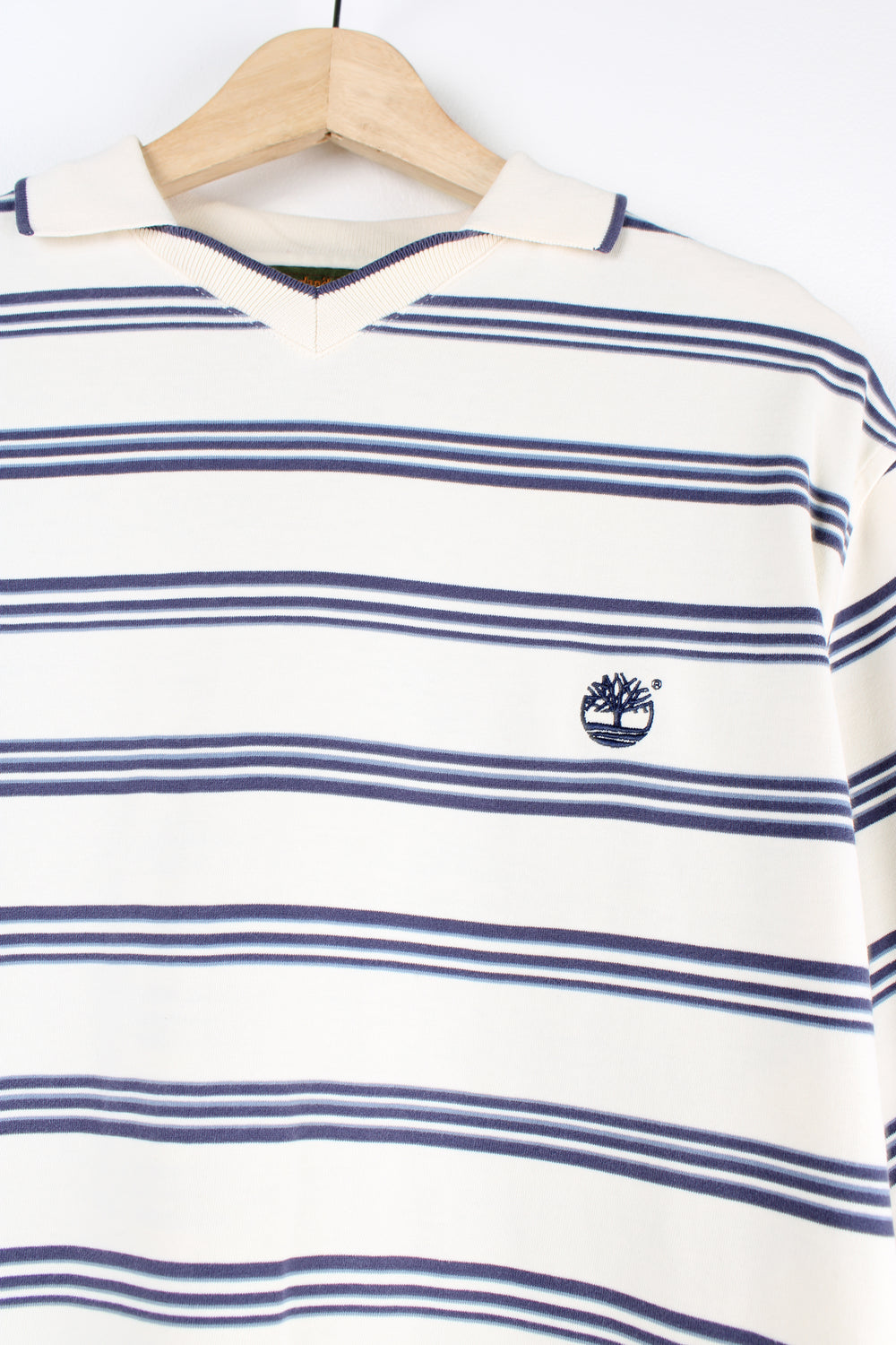 Timberland cream and blue striped polo shirt features signature embroidered logo on the chest