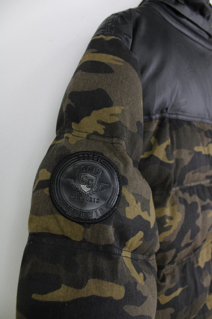 Coogi camouflage zip through puffer coat, features circular badge on the sleeve and multiple pockets 