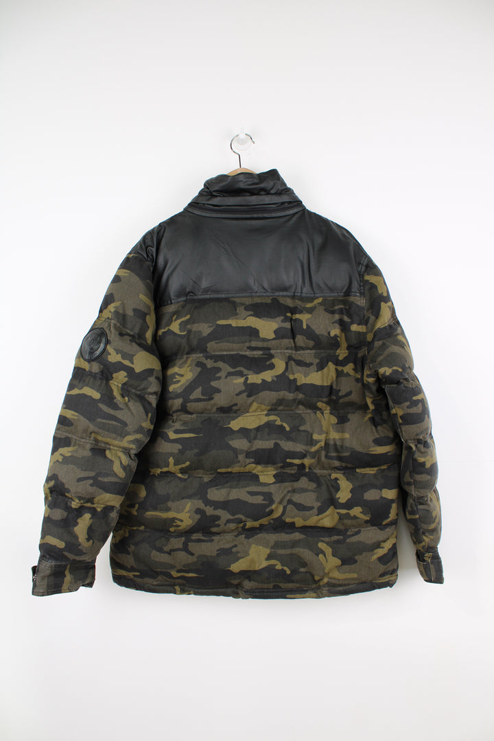 Coogi camouflage zip through puffer coat, features circular badge on the sleeve and multiple pockets 