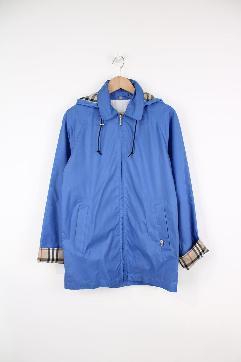 Vintage Burberry London blue lightweight, zip through jacket. Features signature nova check lining on the cuffs and drawstring hood