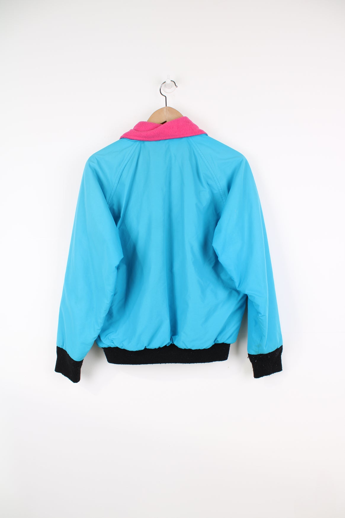 Vintage Woolrich bright blue zip through bomber jacket features black contrast zippers, ,pink fleece lining and logo on the chest