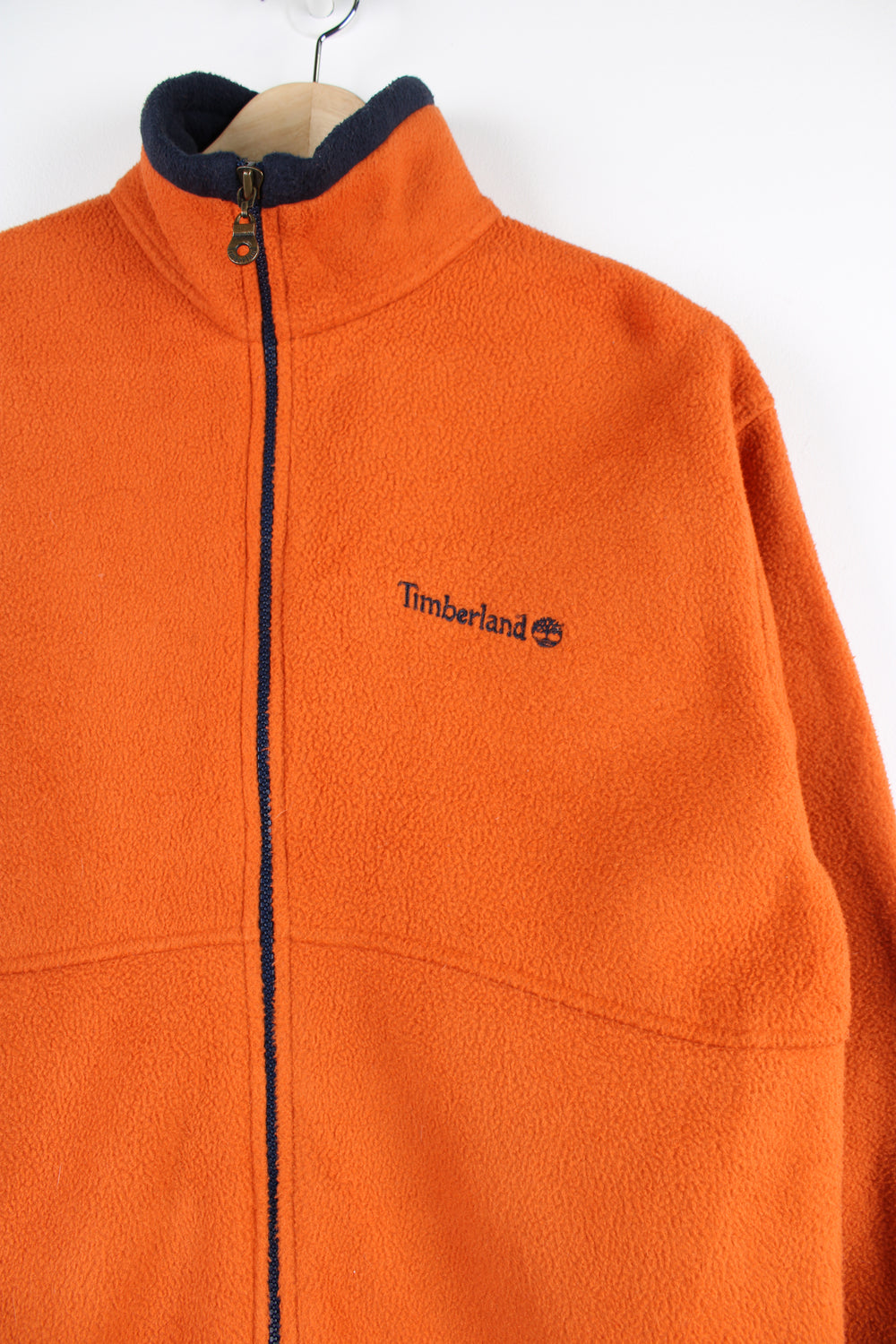 Timberland orange zip through fleece features embroidered logo on the front