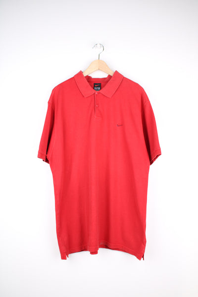 Nike Polo Shirt in a red colourway, button up collar, short sleeved and has the swoosh logo embroidered on the front.