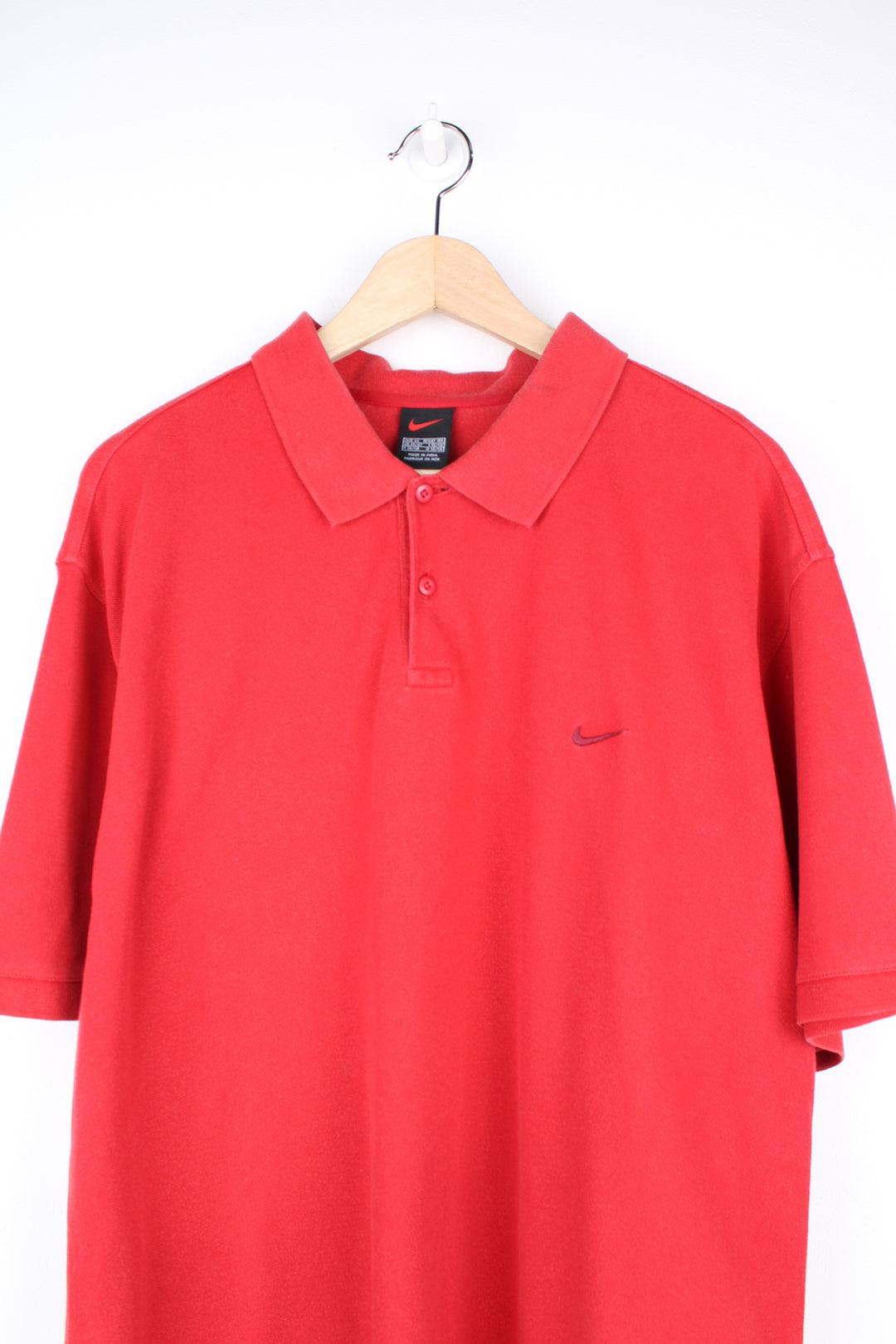 Nike Polo Shirt in a red colourway, button up collar, short sleeved and has the swoosh logo embroidered on the front.