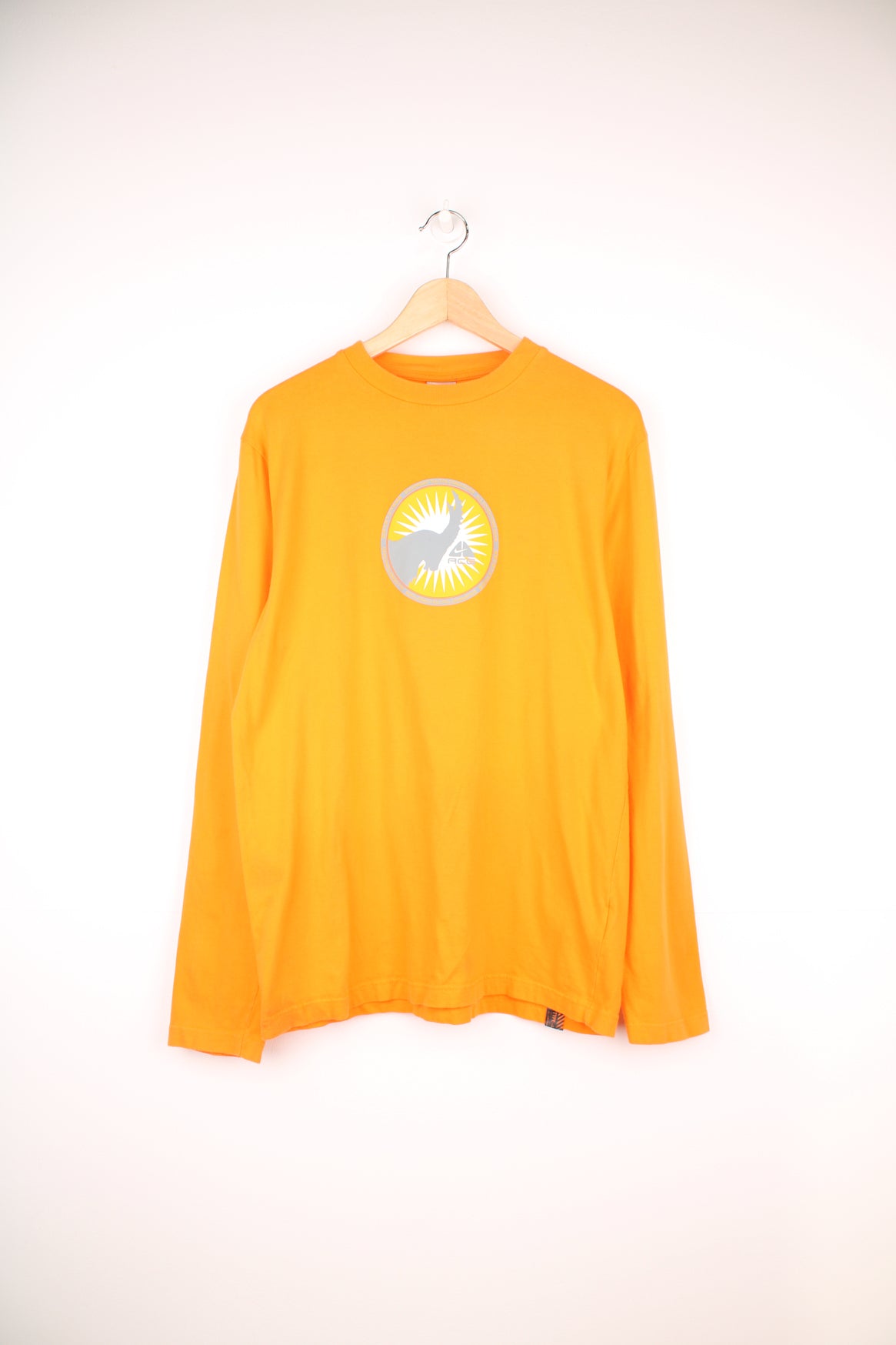 Nike ACG Long Sleeved T-Shirt in a orange and grey colourway, and has a elephant graphic design printed alongside the logo on the front and back.