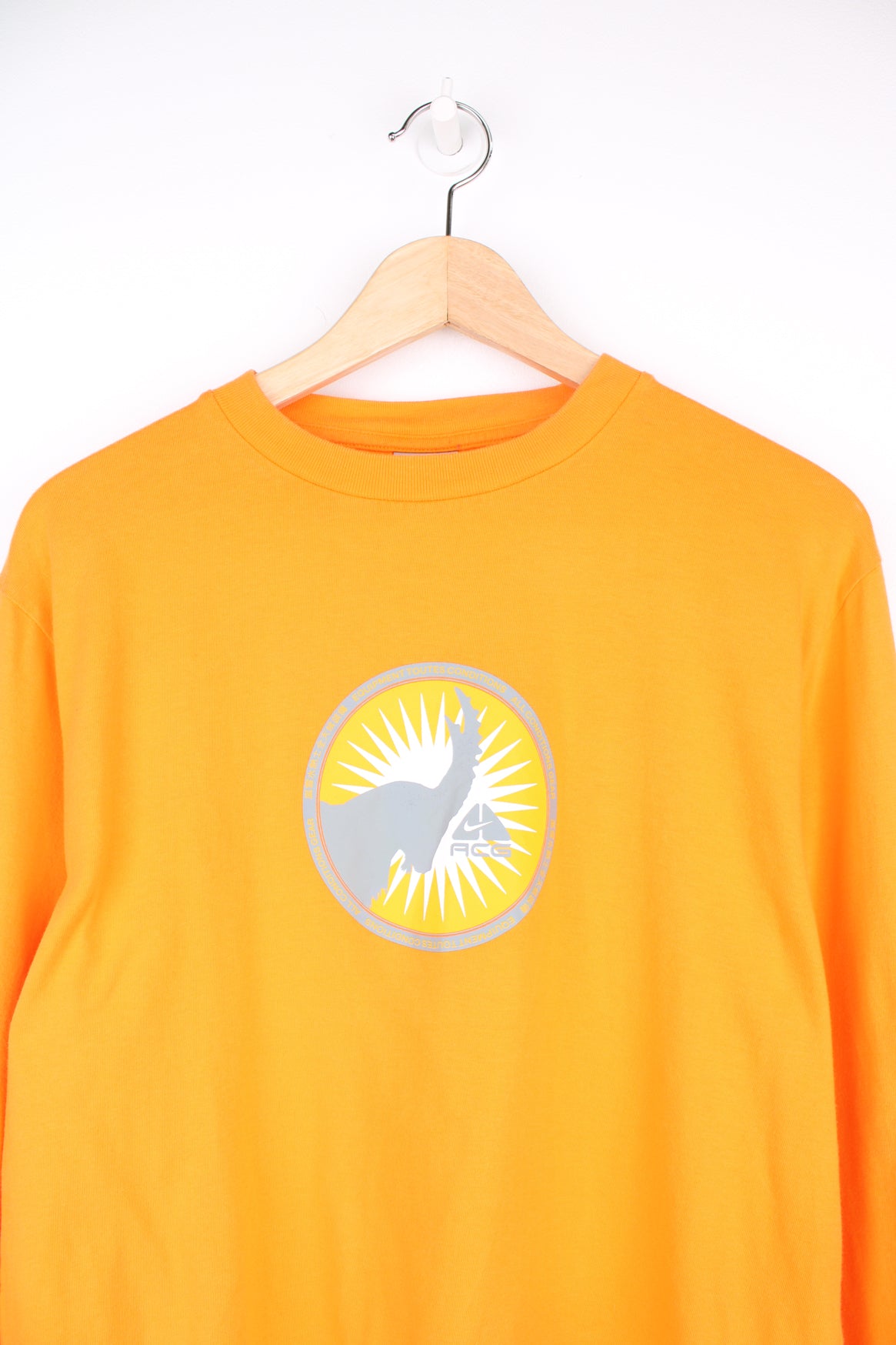 Nike ACG Long Sleeved T-Shirt in a orange and grey colourway, and has a elephant graphic design printed alongside the logo on the front and back.