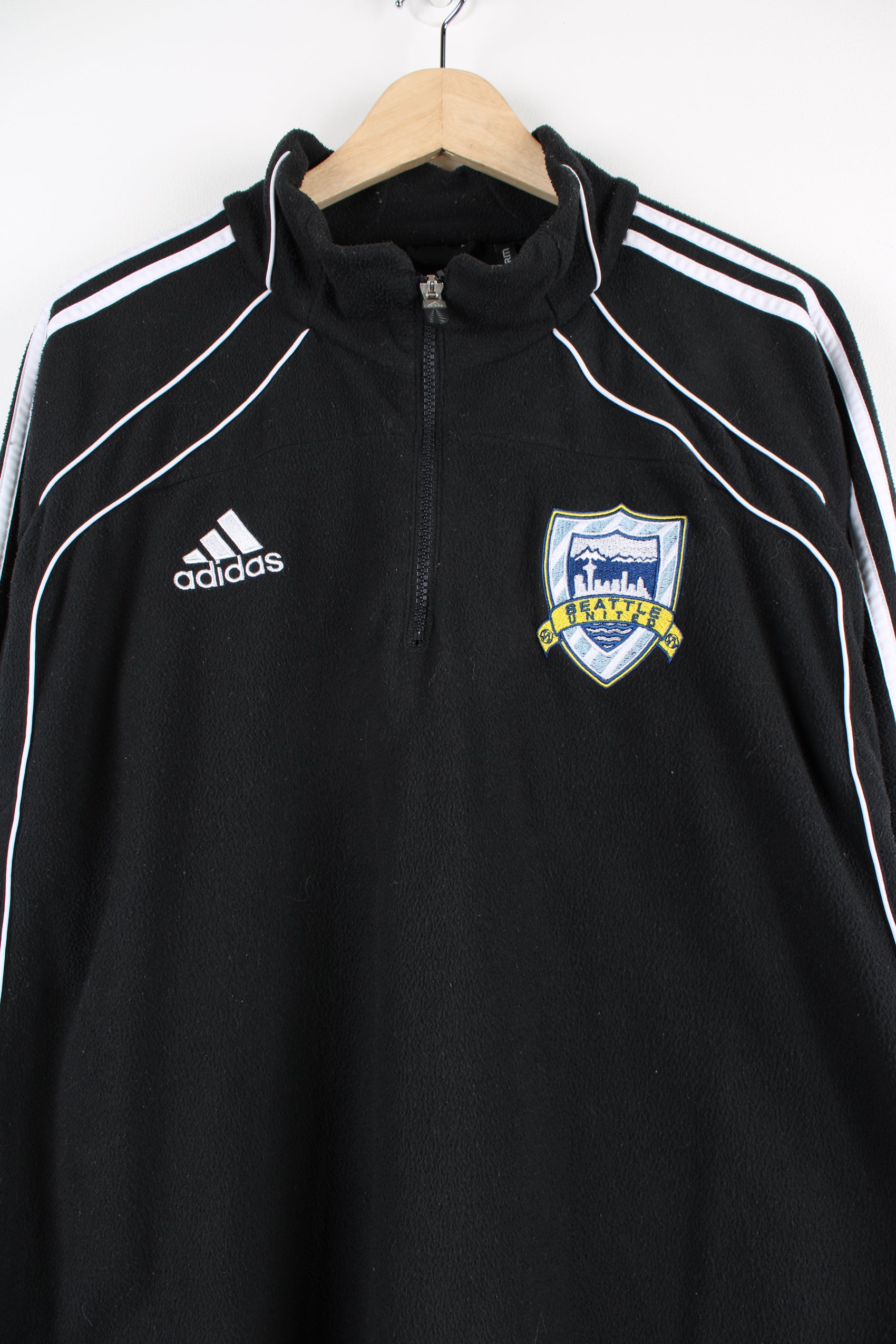 Seattle United 1/4 zip pullover fleece by Adidas features embroidered spell-out across the chest