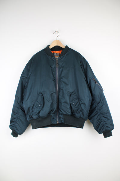 Schott Type MA-1 Flight Jacket in a blue and orange colourway, zip up, side pockets and one on the left sleeve, insulated lining, and has the logo embroidered on the front.