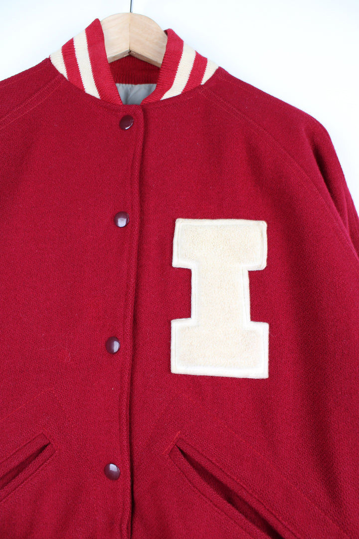 Vintage 60's Woollen Varsity Jacket in a red and white colourway, made in USA by TM Athletics, button up with side pockets, nylon lining, and has the initial 'I' embroidered on the chest.