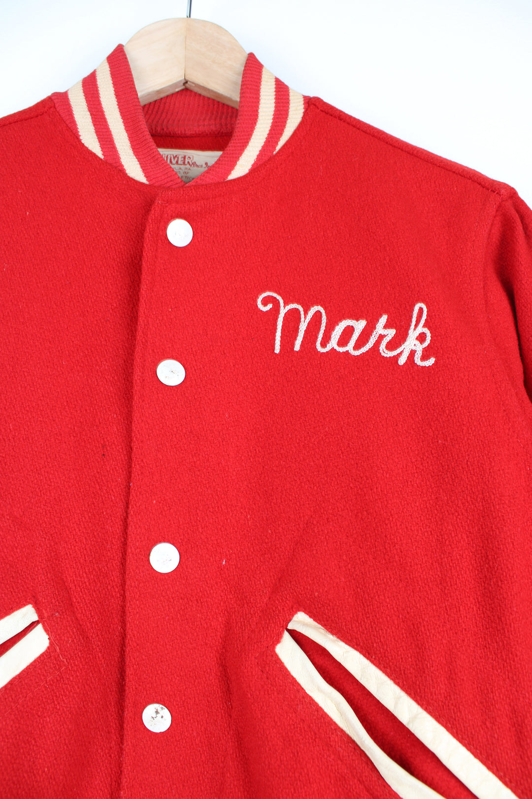 Vintage 60's Woollen Varsity Jacket in a red and white colourway, button up with side pockets, and has 'Mark' embroidered on the front as well as 'Westbrook Park B.C.' embroidered spell out on the back.