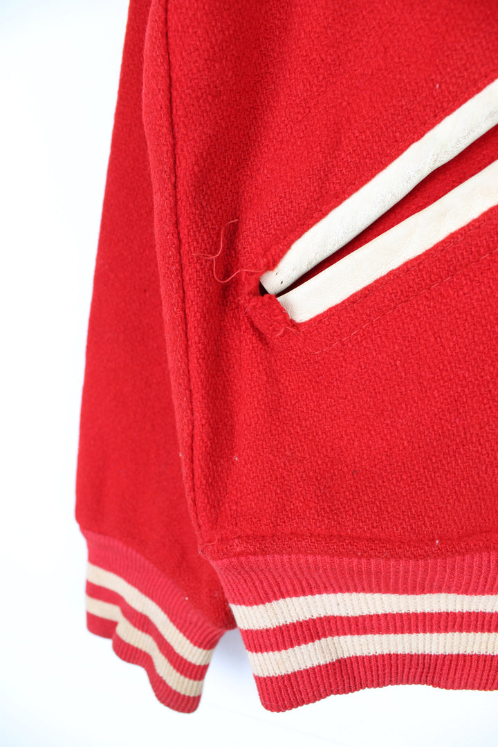 Vintage 60's Woollen Varsity Jacket in a red and white colourway, button up with side pockets, and has 'Mark' embroidered on the front as well as 'Westbrook Park B.C.' embroidered spell out on the back.