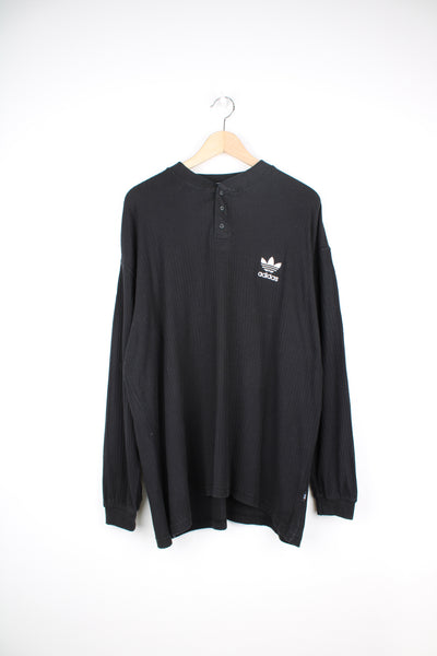 Adidas Long Sleeved Shirt in a black colourway, knitted cotton, quarter button up, and has the logo embroidered on the front.